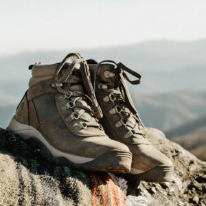 A pair of boots sitting atop a rock above a scenic canyon view