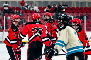 Ice Dawgs defenseman Truman Haugen celebrates a goal with 3 teammates